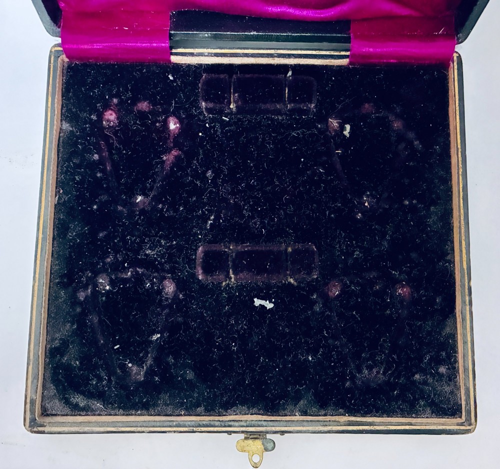 A cased set of four Victorian shell-shaped silver salt cellars with gilded interiors and two matching silver spoons in a velvet-lined box. View IV