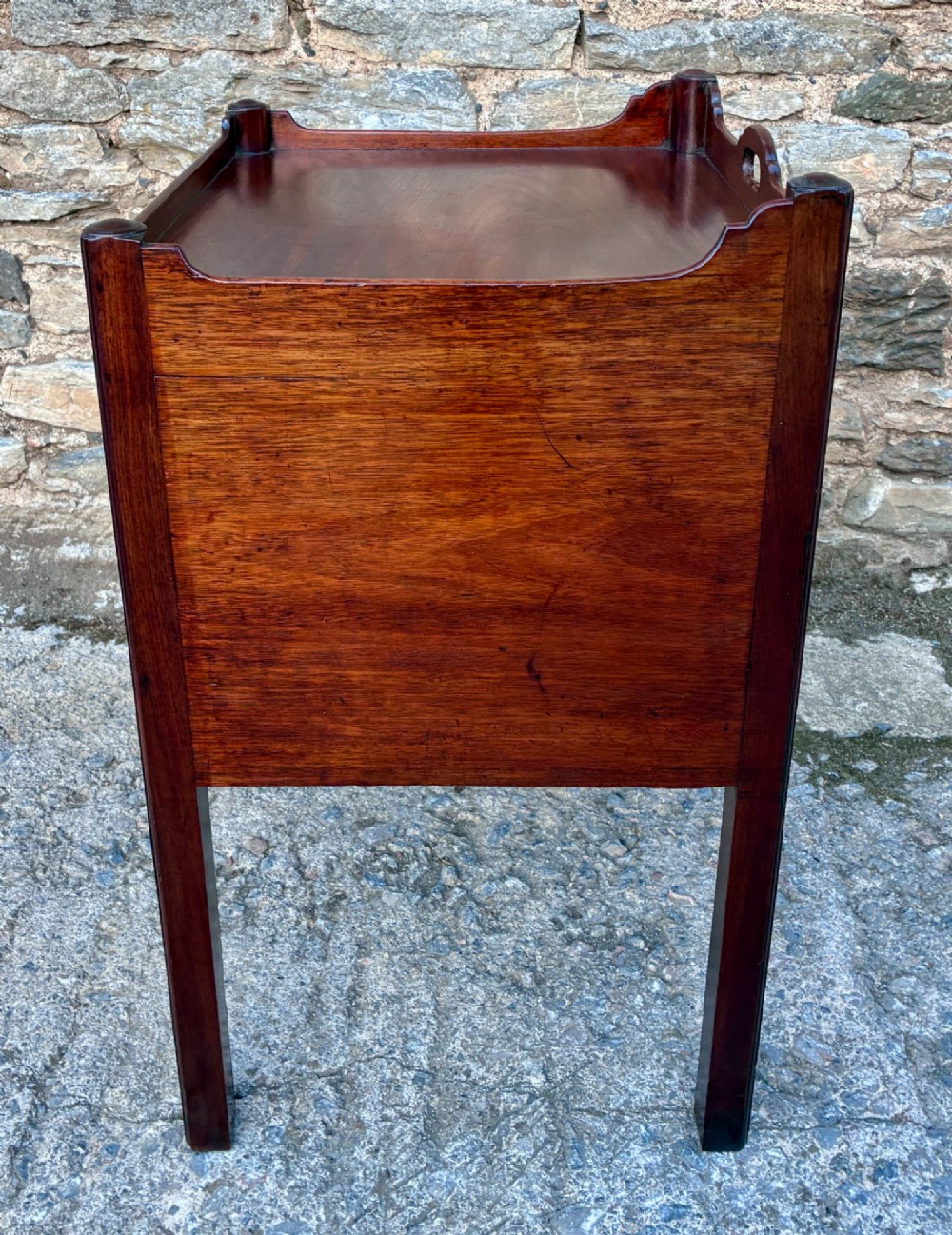 A Georgian mahogany tray top commode featuring a gallery top with pierced carrying handles, double cupboard doors, and a lower drawer on square legs. View IX