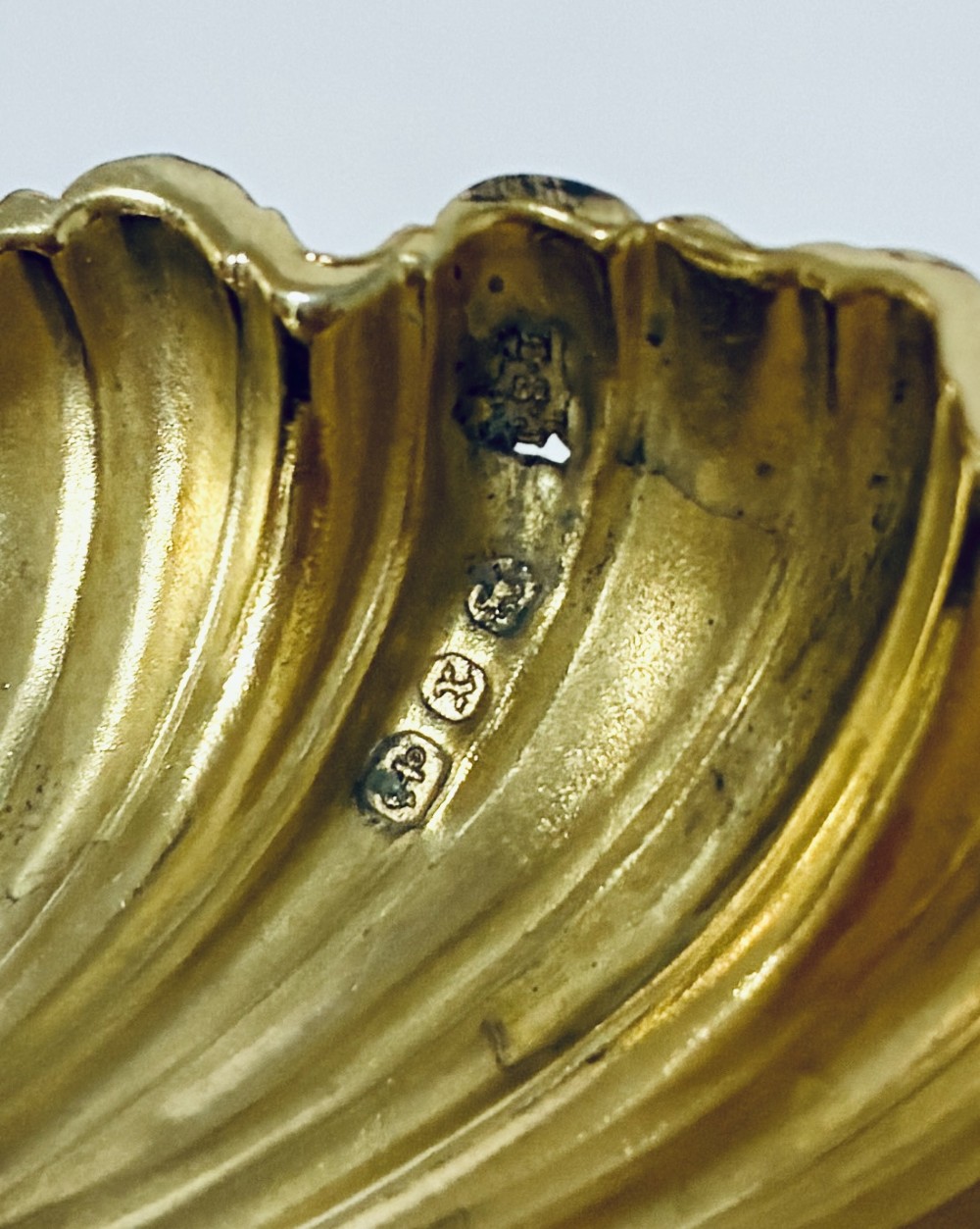 A cased set of four Victorian shell-shaped silver salt cellars with gilded interiors and two matching silver spoons in a velvet-lined box. View XII