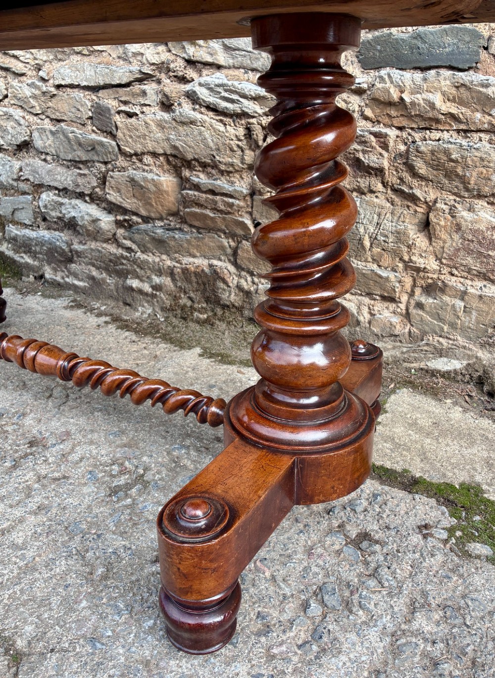 A Victorian walnut library writing table featuring a green inset leather top, carved gadrooned edge, twin drawers, and spiral barley twist legs connected by a central stretcher. View VIII