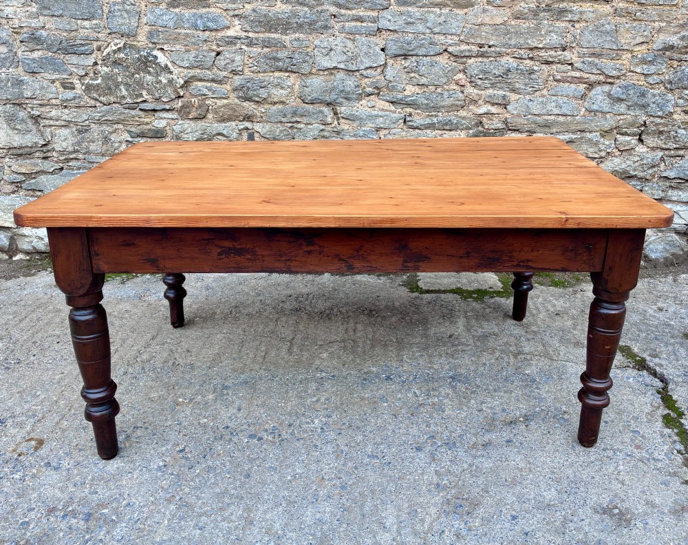 A Victorian pine farmhouse table featuring a light natural timber plank top, two frieze drawers with round wooden knobs, and four dark turned wooden legs. View XIV