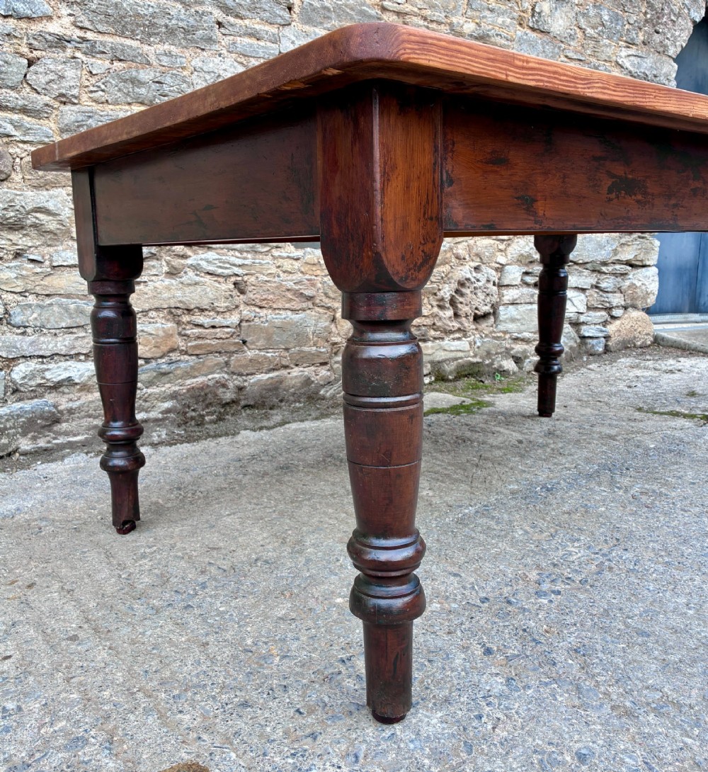 A Victorian pine farmhouse table featuring a light natural timber plank top, two frieze drawers with round wooden knobs, and four dark turned wooden legs. View XV