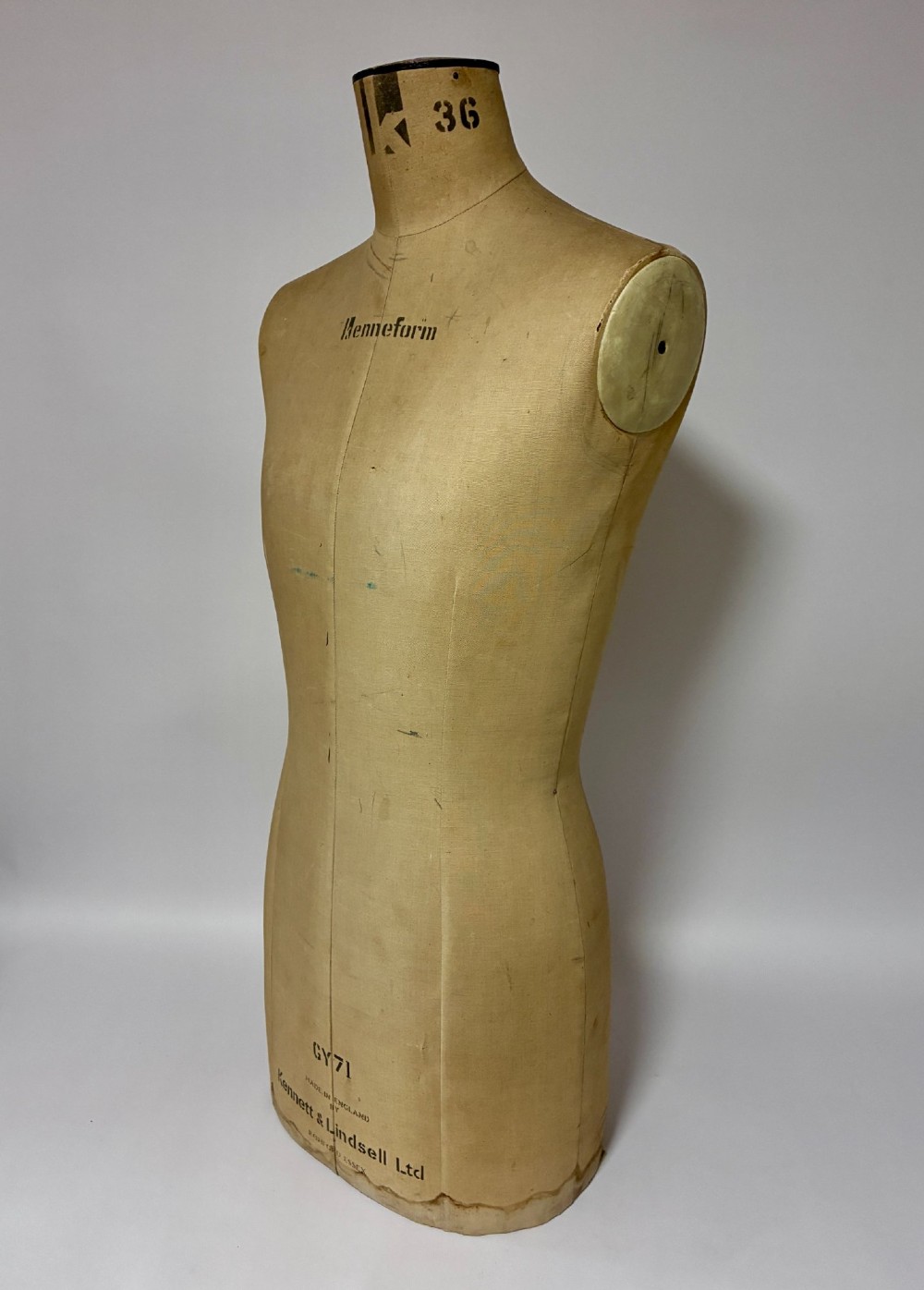 A vintage fabric-covered dressmakers mannequin torso displaying the Kenneform and Kennett and Lindsell maker marks. View IV