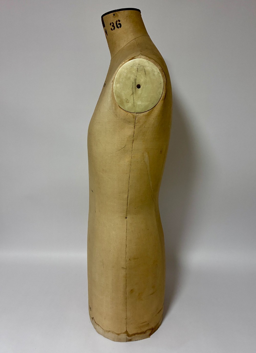 A vintage fabric-covered dressmakers mannequin torso displaying the Kenneform and Kennett and Lindsell maker marks. View V