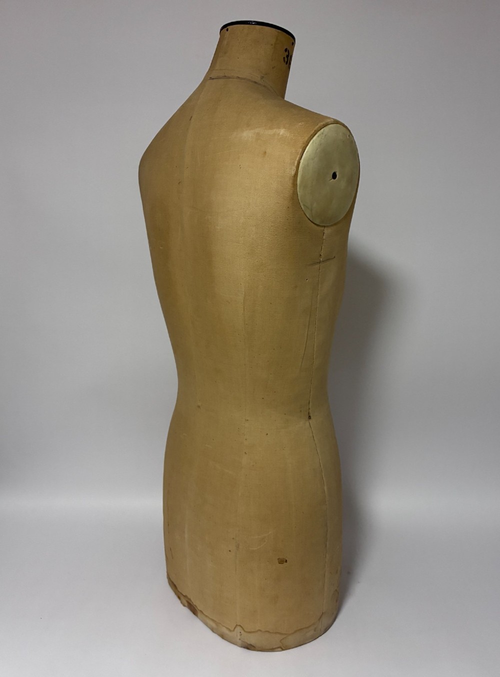 A vintage fabric-covered dressmakers mannequin torso displaying the Kenneform and Kennett and Lindsell maker marks. View VIII