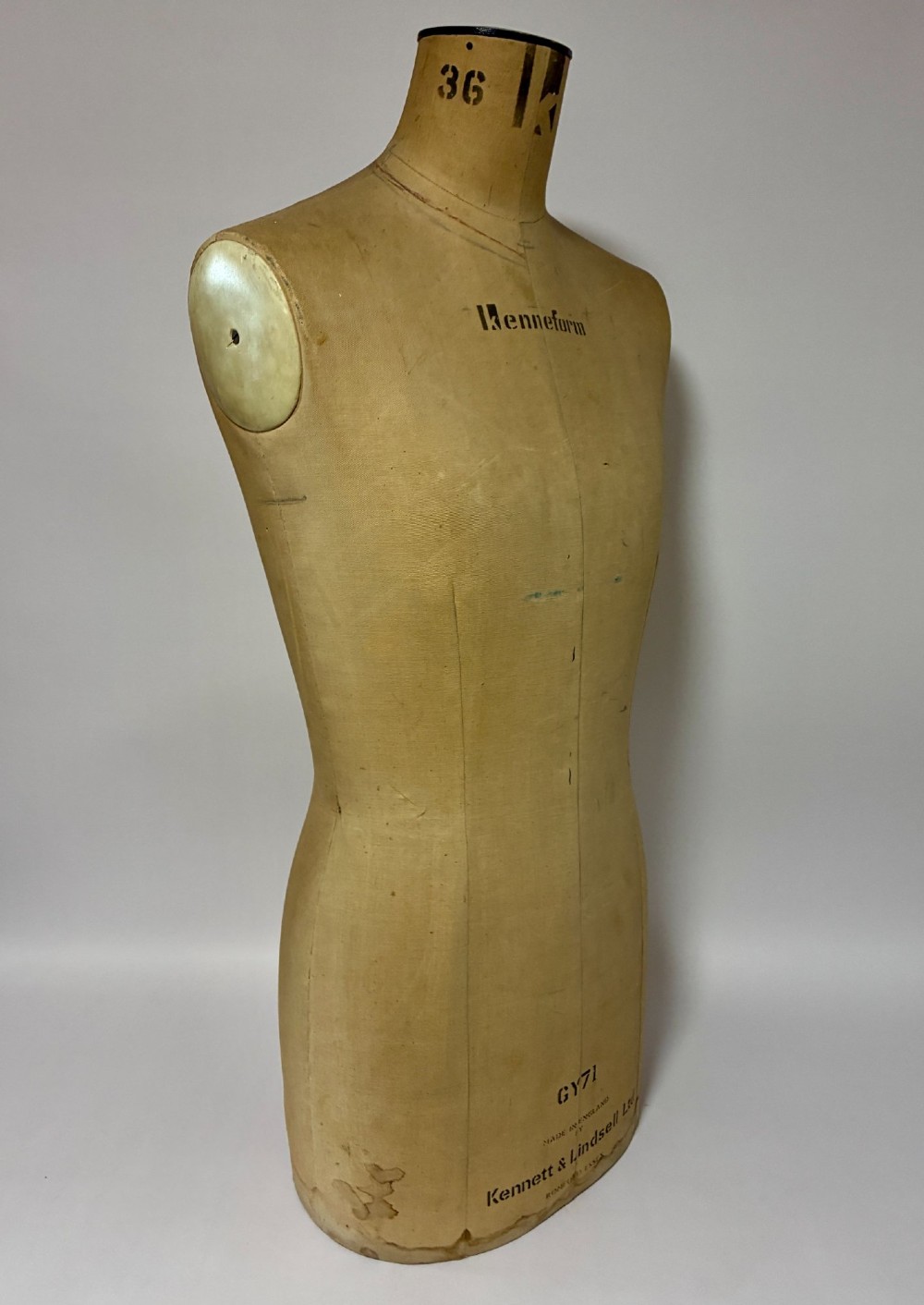A vintage fabric-covered dressmakers mannequin torso displaying the Kenneform and Kennett and Lindsell maker marks. View IX