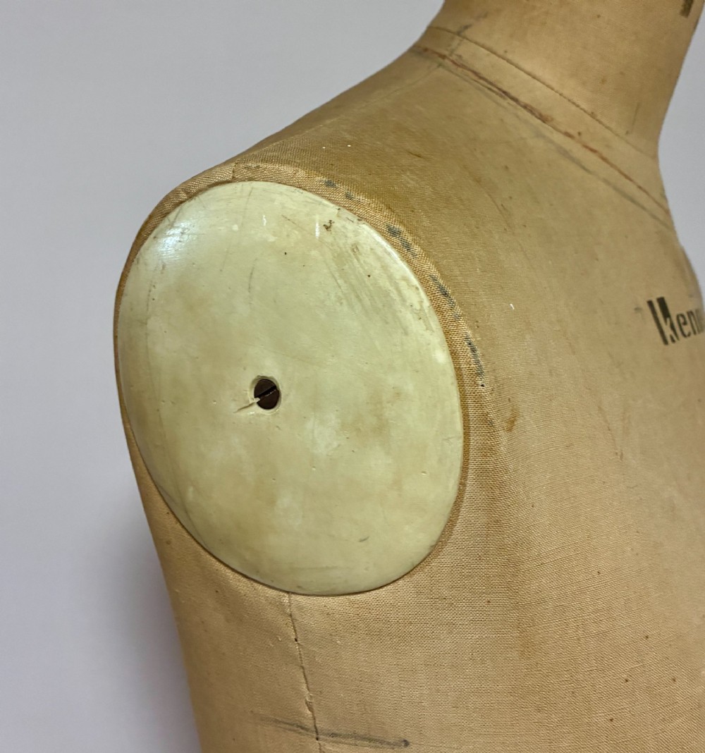 A vintage fabric-covered dressmakers mannequin torso displaying the Kenneform and Kennett and Lindsell maker marks. View X