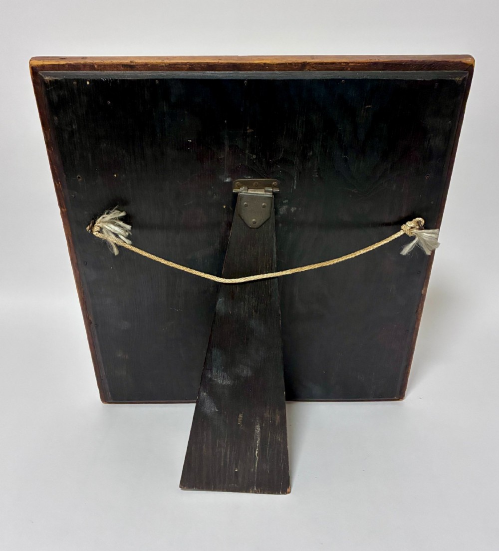 An antique rectangular birds eye maple frame featuring an inner gilt slip rim surrounding a mirror glass plate, supported by an easel stand. View VI