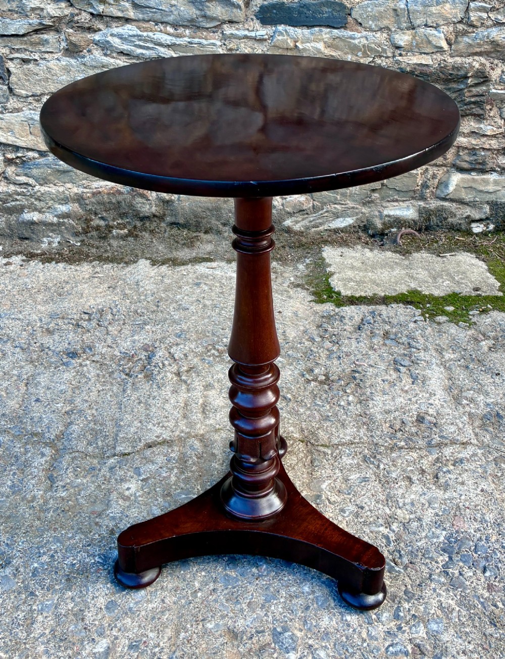 A Victorian mahogany wine table featuring a circular top supported by a turned central pedestal column resting on a tripod base. View III