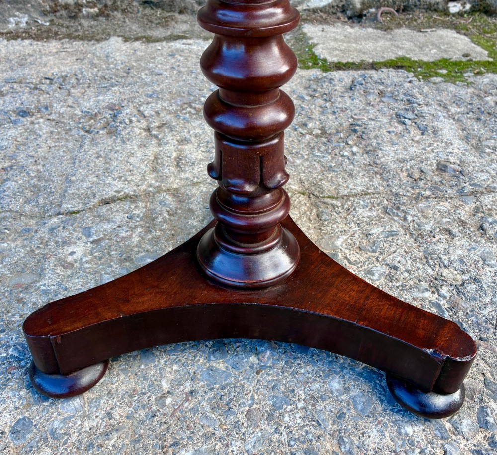 A Victorian mahogany wine table featuring a circular top supported by a turned central pedestal column resting on a tripod base. View IV