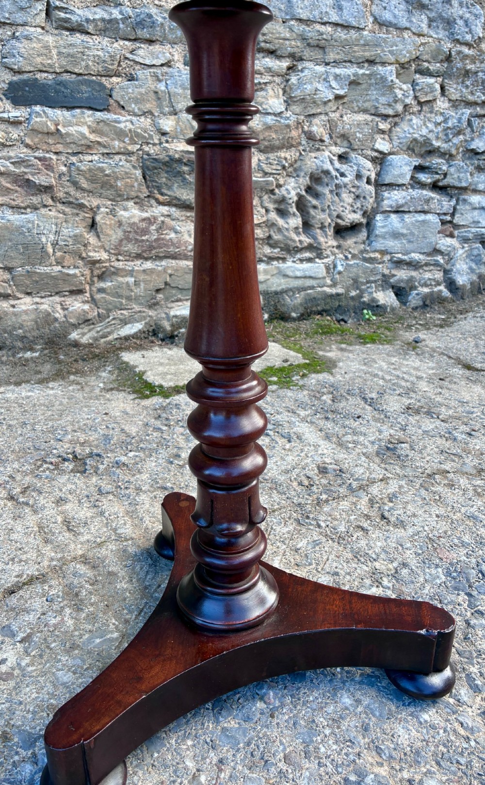 A Victorian mahogany wine table featuring a circular top supported by a turned central pedestal column resting on a tripod base. View V
