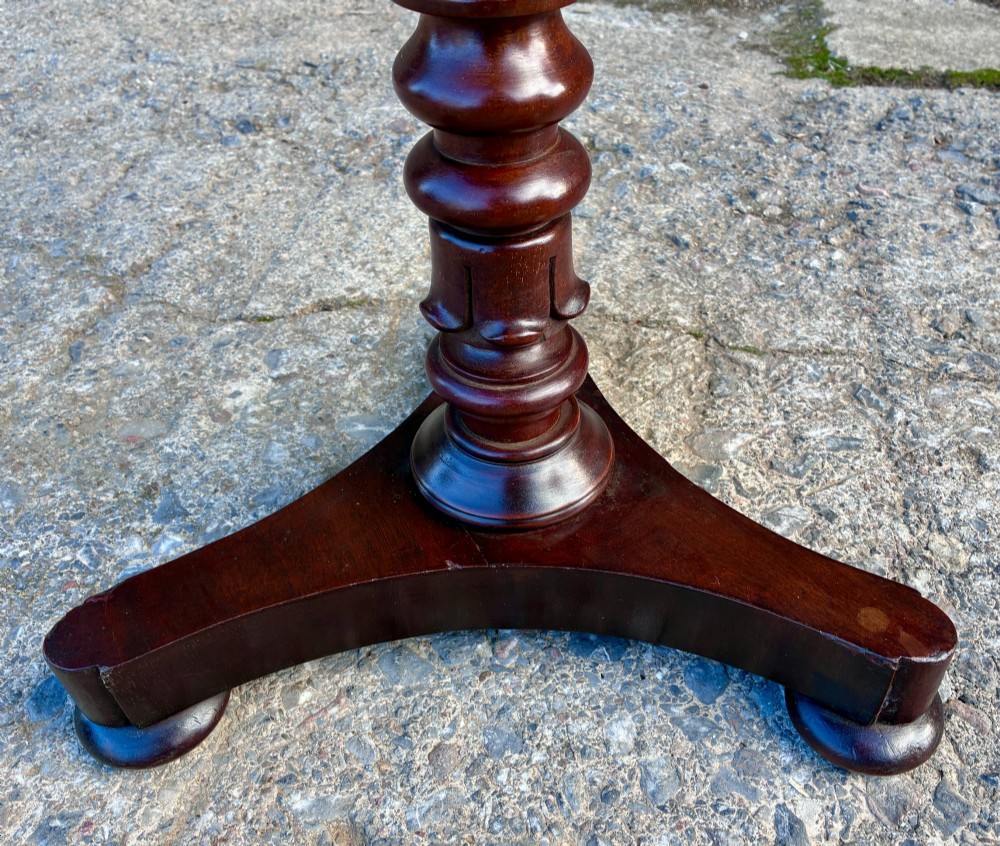 A Victorian mahogany wine table featuring a circular top supported by a turned central pedestal column resting on a tripod base. View IX