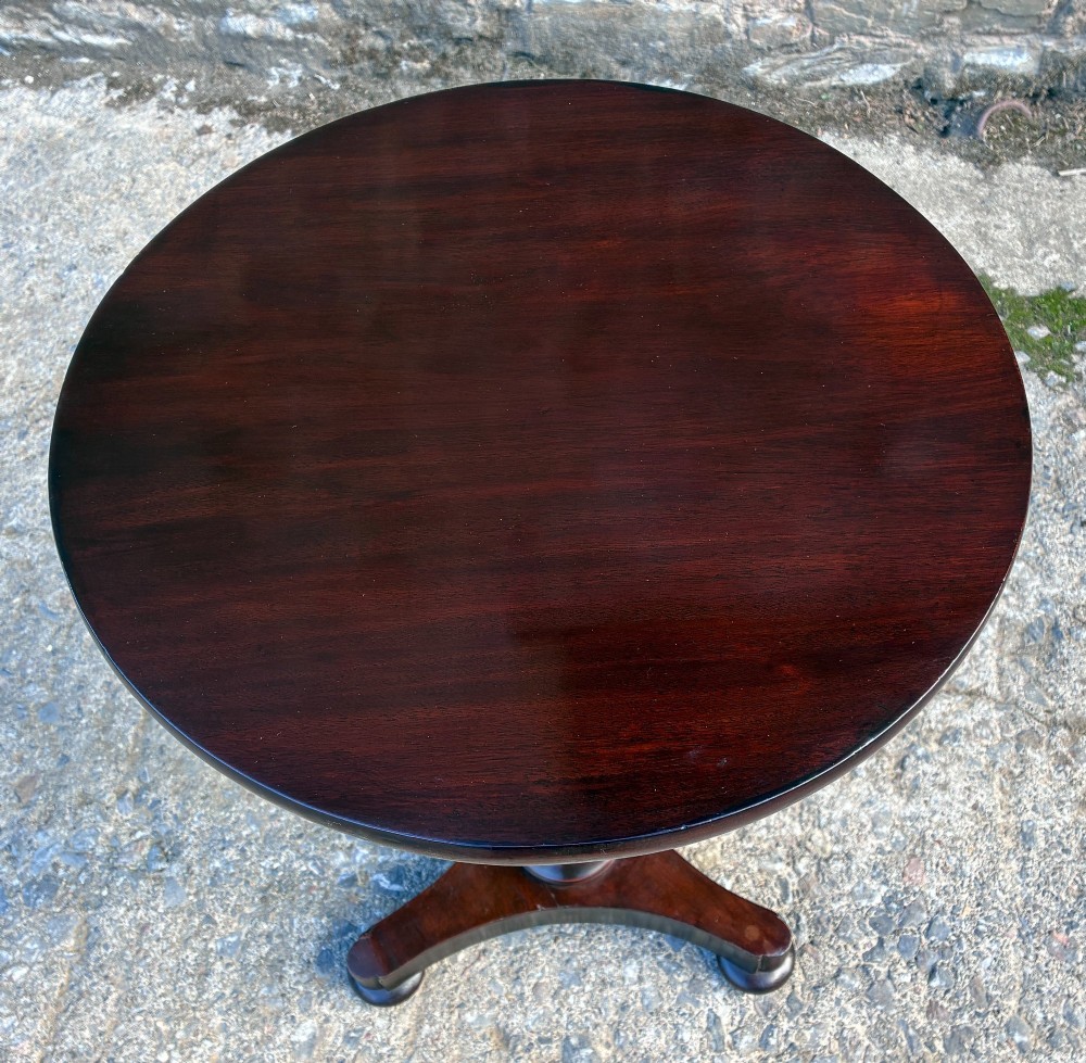 A Victorian mahogany wine table featuring a circular top supported by a turned central pedestal column resting on a tripod base. View X