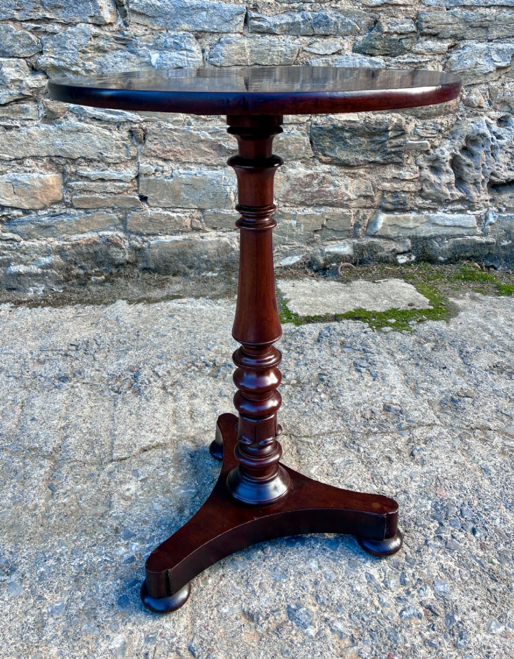 A Victorian mahogany wine table featuring a circular top supported by a turned central pedestal column resting on a tripod base. View XI