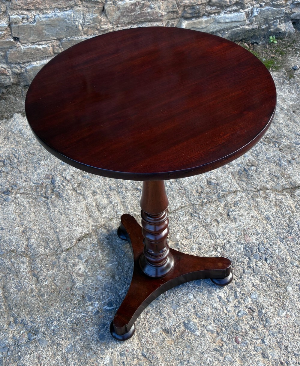 A Victorian mahogany wine table featuring a circular top supported by a turned central pedestal column resting on a tripod base. View XII