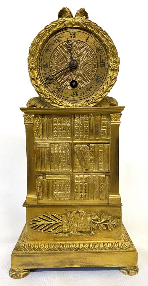 Stunning Antique Regency Gilt Bronze Clock Depicting a Bookshelf Silk Suspension