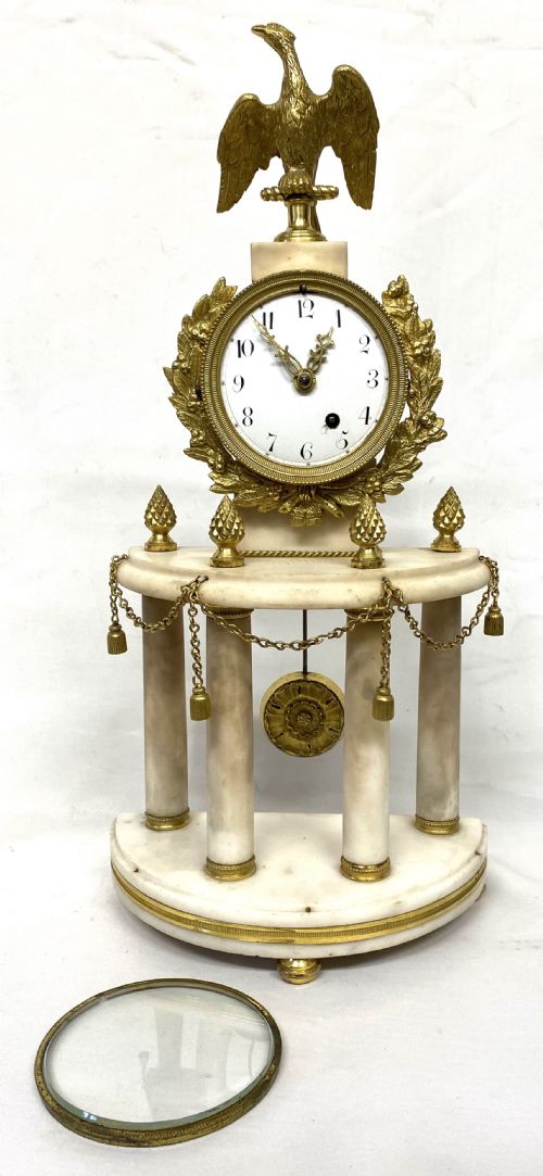 fig 2. An antique Neoclassical portico clock crafted from white alabaster columns and gilt bronze accents, topped with an eagle finial.