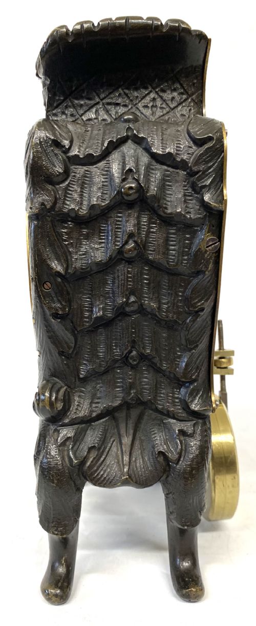 fig 2. An antique miniature bronze mantel clock featuring Rococo scrollwork, cabriole legs, and an engraved gold-tone brass dial with Roman numerals.