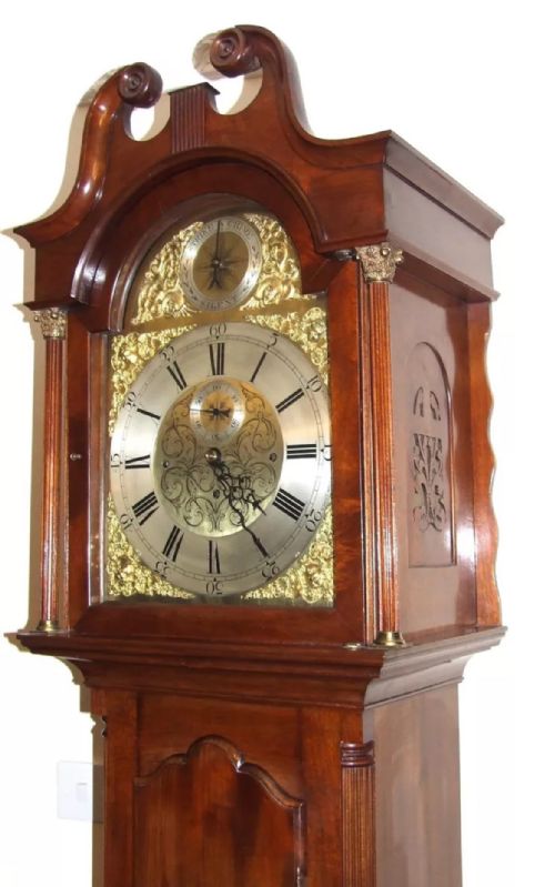 fig 2. A mahogany longcase grandfather clock featuring a swan-neck pediment, brass dial with Roman numerals, and a polished timber cabinet.