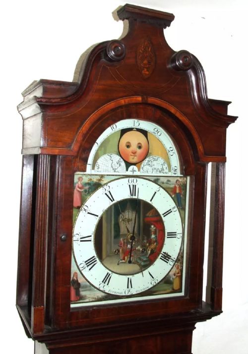 fig 4. An antique mahogany longcase grandfather clock featuring a painted arched dial with a moon phase indicator, swan neck pediment, and flame mahogany inlaid cabinet door.