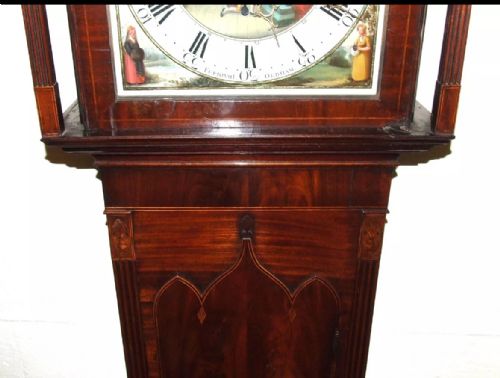 fig 7. An antique mahogany longcase grandfather clock featuring a painted arched dial with a moon phase indicator, swan neck pediment, and flame mahogany inlaid cabinet door.