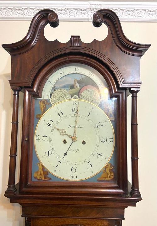 fig 4. A Georgian flame mahogany longcase clock featuring a swan-neck pediment, turned columns, and a painted dial with a rolling moon phase mechanism.