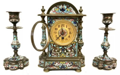 fig 1. A three-piece French late nineteenth-century cloisonne enamel clock garniture set featuring a central arched mantel clock with turned side columns flanked by a pair of matching enamelled candlesticks.