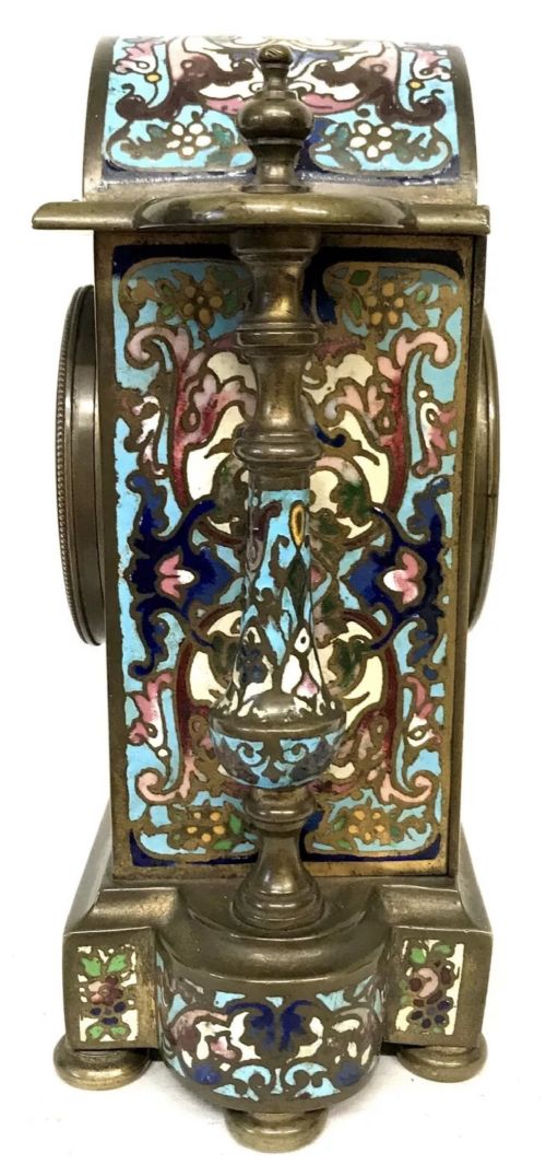 fig 2. A three-piece French late nineteenth-century cloisonne enamel clock garniture set featuring a central arched mantel clock with turned side columns flanked by a pair of matching enamelled candlesticks.