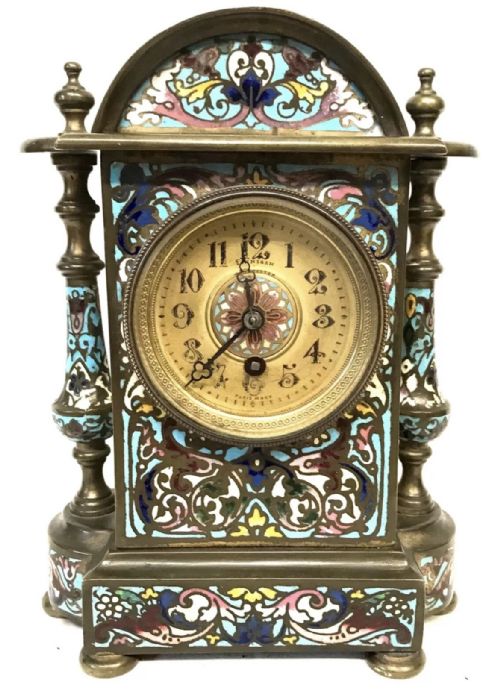 fig 3. A three-piece French late nineteenth-century cloisonne enamel clock garniture set featuring a central arched mantel clock with turned side columns flanked by a pair of matching enamelled candlesticks.