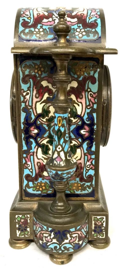 fig 4. A three-piece French late nineteenth-century cloisonne enamel clock garniture set featuring a central arched mantel clock with turned side columns flanked by a pair of matching enamelled candlesticks.