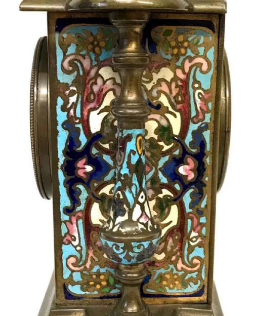 fig 6. A three-piece French late nineteenth-century cloisonne enamel clock garniture set featuring a central arched mantel clock with turned side columns flanked by a pair of matching enamelled candlesticks.