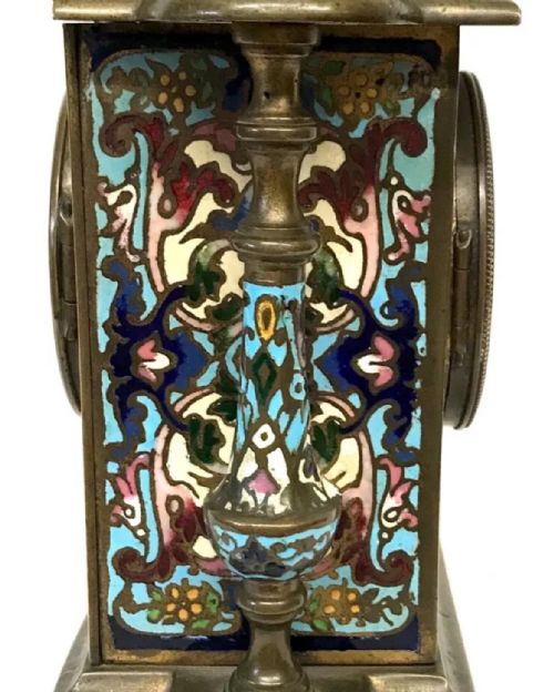 fig 7. A three-piece French late nineteenth-century cloisonne enamel clock garniture set featuring a central arched mantel clock with turned side columns flanked by a pair of matching enamelled candlesticks.