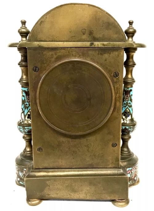 fig 10. A three-piece French late nineteenth-century cloisonne enamel clock garniture set featuring a central arched mantel clock with turned side columns flanked by a pair of matching enamelled candlesticks.