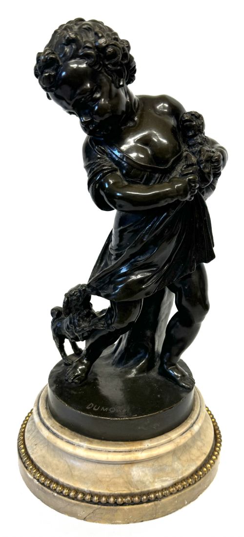 fig 1. A pair of patinated dark bronze sculptures of children playing with animals, mounted on circular marble bases.