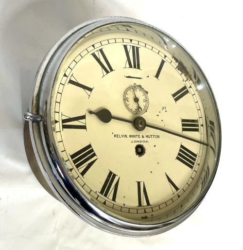 fig 1. An antique circular nickel-plated brass ships bulkhead clock featuring a cream dial with Roman numerals and a subsidiary seconds dial.