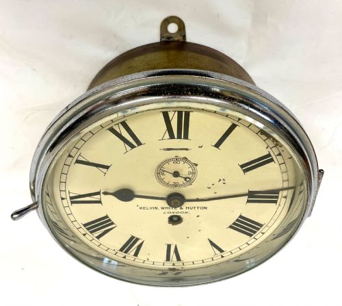 fig 3. An antique circular nickel-plated brass ships bulkhead clock featuring a cream dial with Roman numerals and a subsidiary seconds dial.