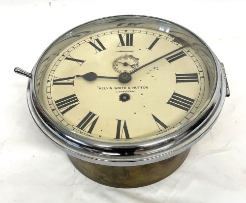fig 4. An antique circular nickel-plated brass ships bulkhead clock featuring a cream dial with Roman numerals and a subsidiary seconds dial.