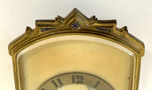 fig 3. An antique miniature gilt metal easel clock featuring a painted landscape dial surrounded by champleve enamel floral decoration at the base.