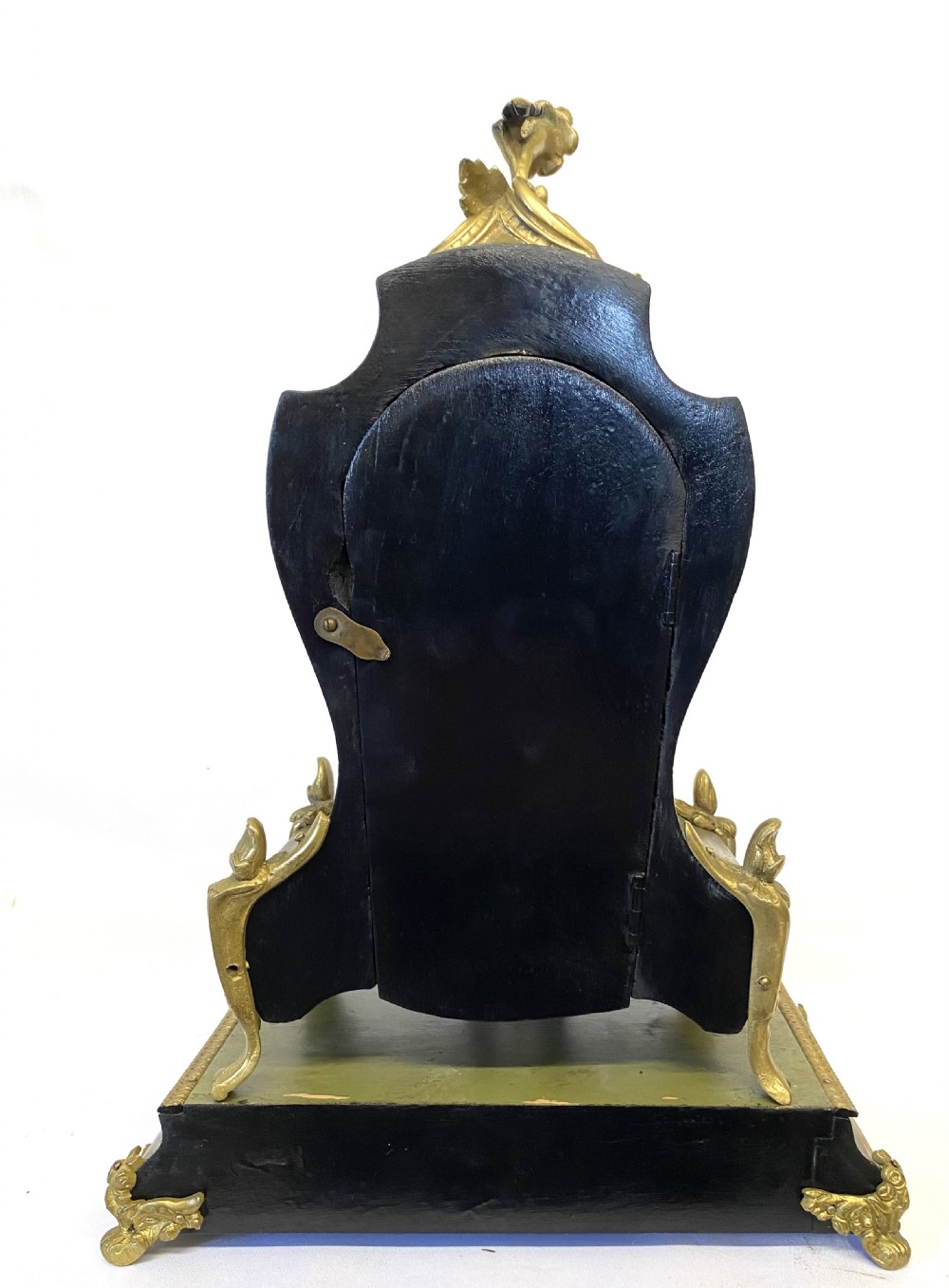 An olive green hand-painted French mantel clock set on a matching plinth stand with gilded bronze ormolu mounts, floral motifs, and a central circular dial with enamel Roman numeral markers. View VII
