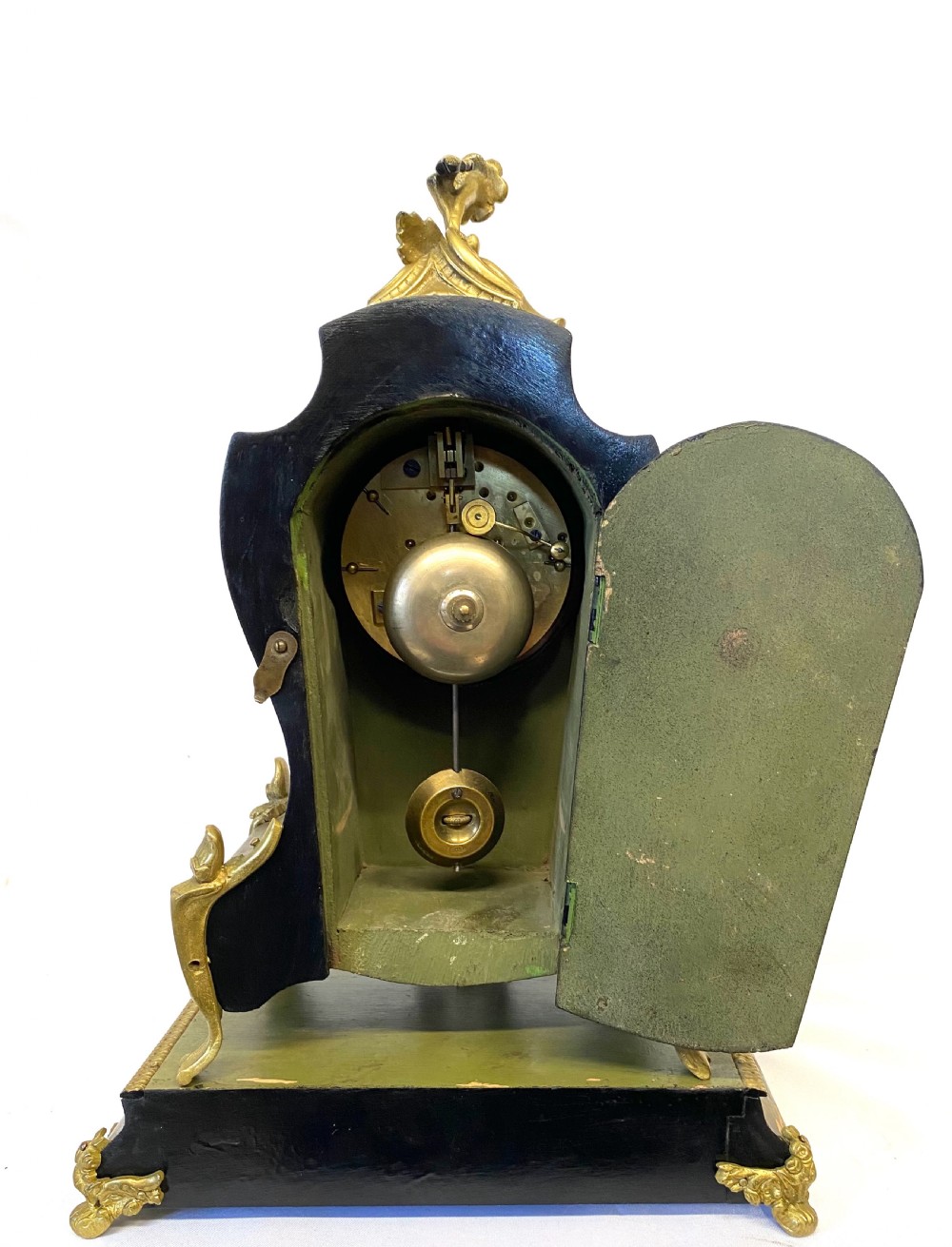 An olive green hand-painted French mantel clock set on a matching plinth stand with gilded bronze ormolu mounts, floral motifs, and a central circular dial with enamel Roman numeral markers. View VIII