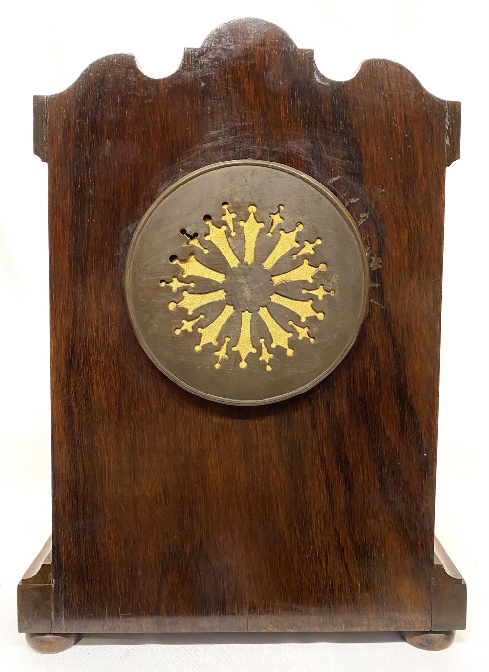 An antique rosewood mantel clock featuring intricate marquetry inlays of figures, swags, and a globe surrounding a circular dial with Roman numerals. View IX
