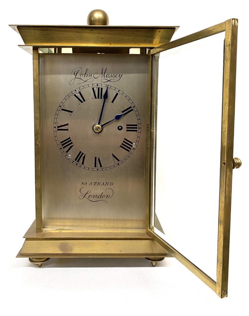 An antique brass four-glass library clock featuring an engraved silvered dial with Roman numerals and glass side panels. View II