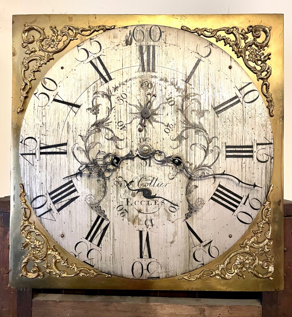 A mahogany longcase clock featuring a swan-neck pediment, brass arch dial with silvered chapter ring, fluted columns, and a shaped trunk door. View XIX