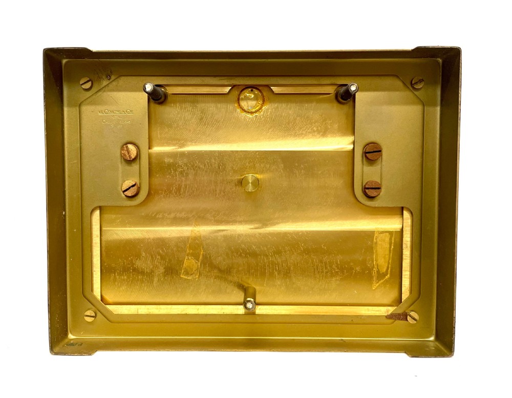 A mid-twentieth-century Jaeger-LeCoultre Atmos clock featuring a rectangular gilt brass frame with glass side panels exposing the mechanical movement and white dial. View XIX
