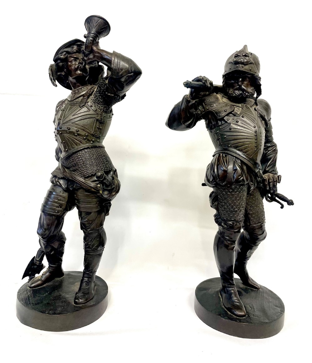 A pair of dark patinated Victorian bronze figures depicting armoured cavalier soldiers standing on circular bases. View II