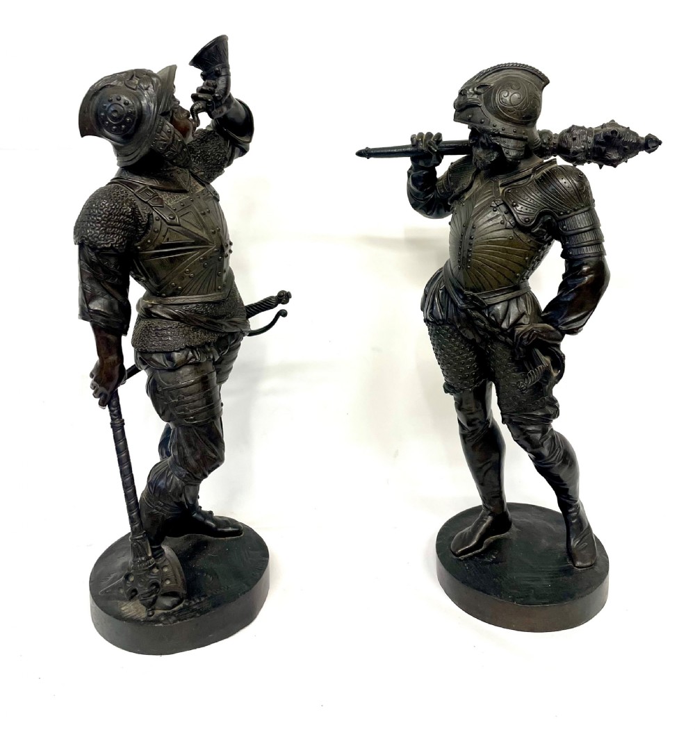 A pair of dark patinated Victorian bronze figures depicting armoured cavalier soldiers standing on circular bases. View IV