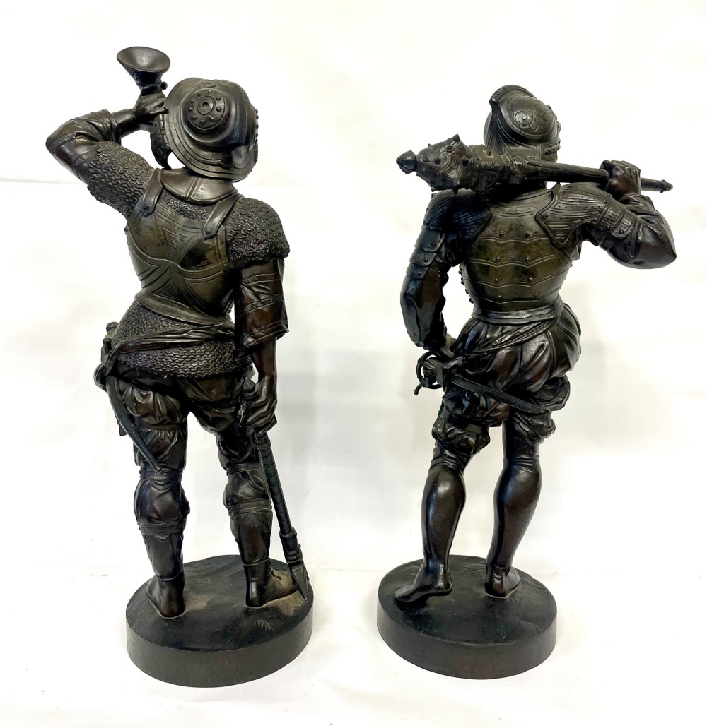 A pair of dark patinated Victorian bronze figures depicting armoured cavalier soldiers standing on circular bases. View VII