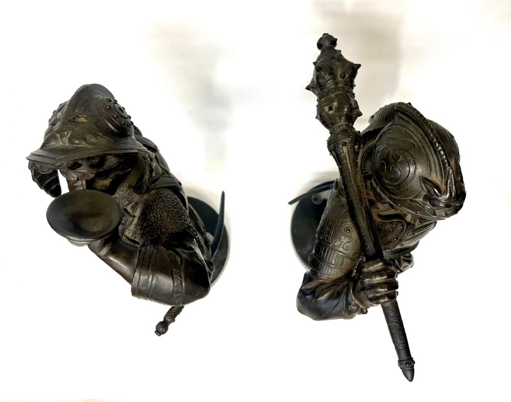 A pair of dark patinated Victorian bronze figures depicting armoured cavalier soldiers standing on circular bases. View VIII