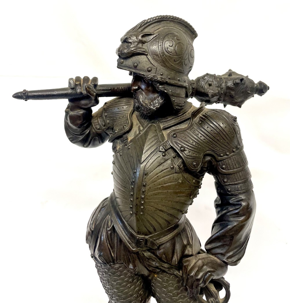 A pair of dark patinated Victorian bronze figures depicting armoured cavalier soldiers standing on circular bases. View XVIII