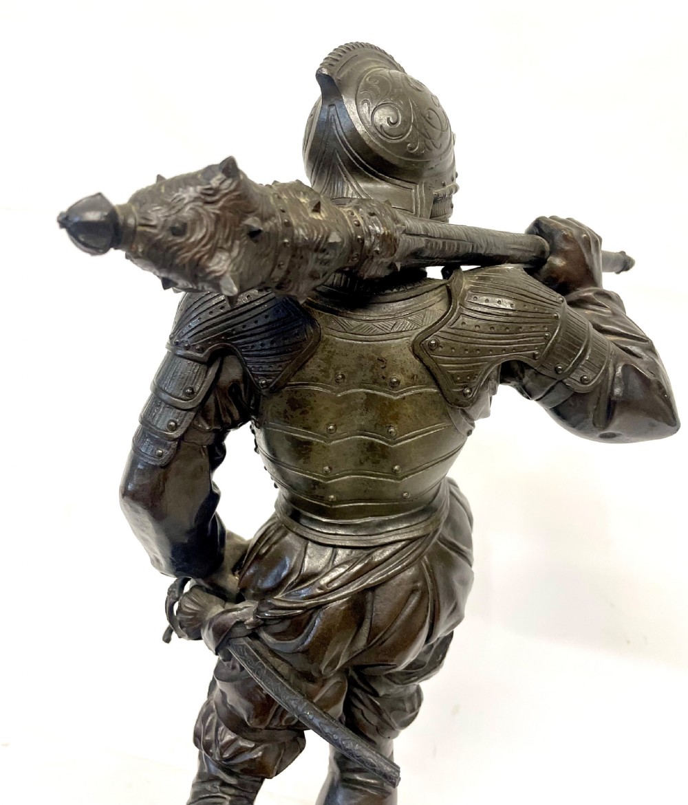 A pair of dark patinated Victorian bronze figures depicting armoured cavalier soldiers standing on circular bases. View XX